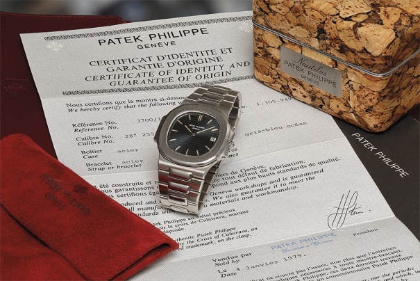 An attractive, rare and large stainless steel wristwatch with date, bracelet, original Certificate of Origin, and original cork presentation box.
